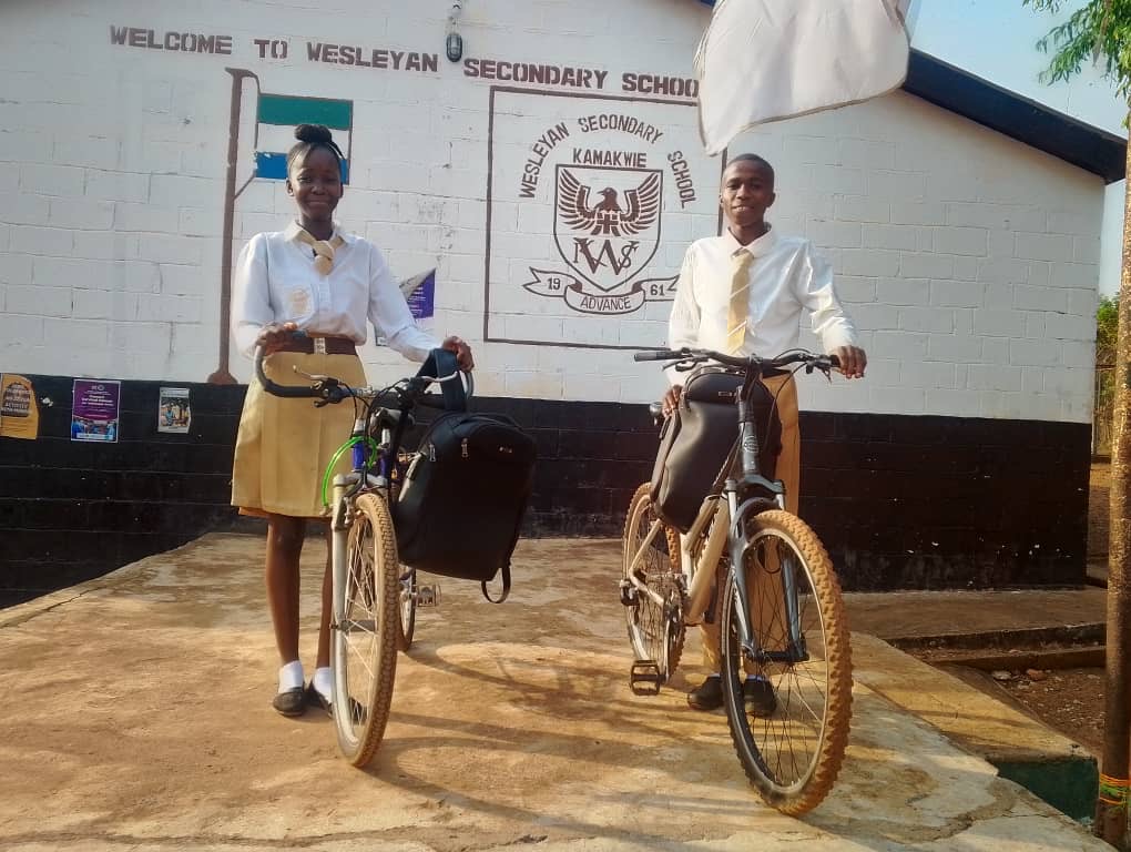 Students receiving bicycles at a community school distribution event